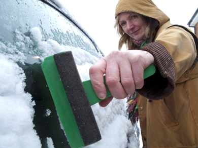 Scraping ice off of a car windscreen